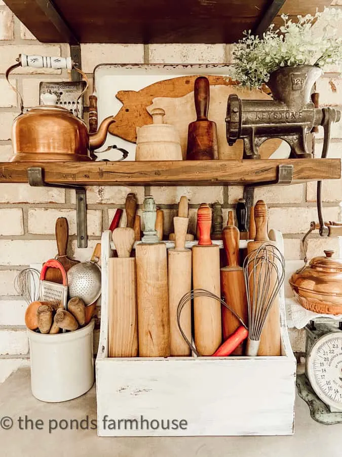 add vintage rolling pins to an old tool box to decorate a modern farmhouse kitchen.