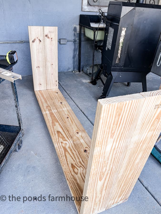 Top and bottom of cabinet unit being attached for DIY reclaimed window cabinet.