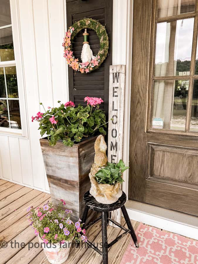 DIY Planters, aged clay pots, chippy stool, concrete rabbit planter and fresh geraniums.  