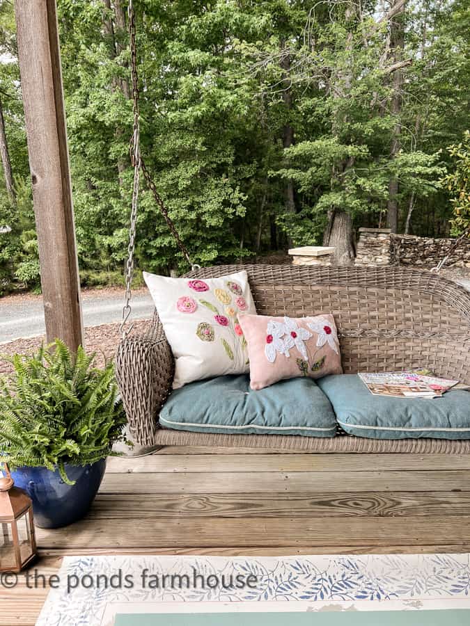 DIY Scrap Fabric Decorative Pillow covers on porch swing.