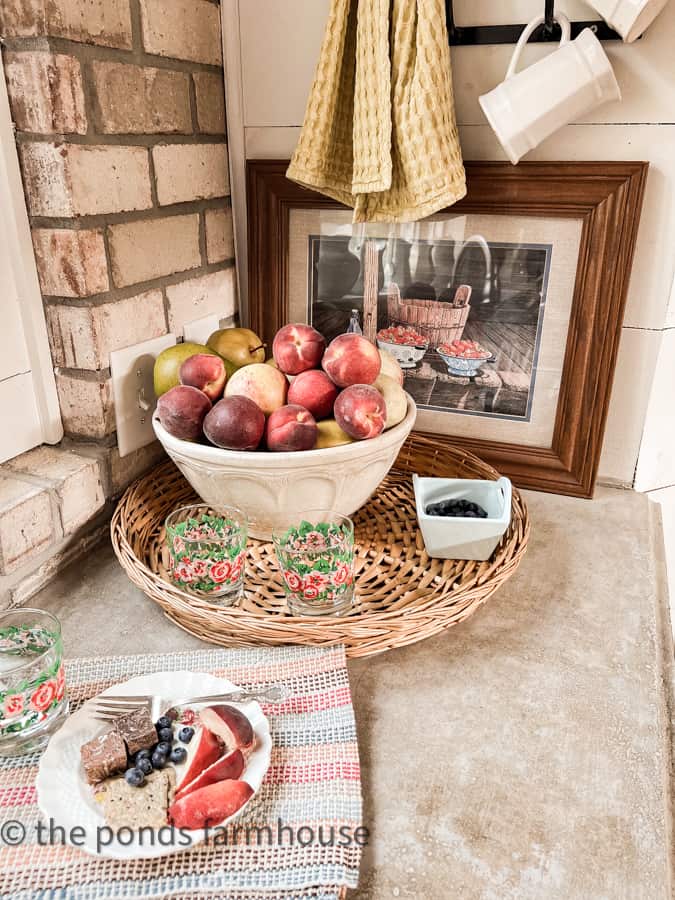 Budget Thrift Store Decor Art, woven basket tray and vintage bowl filled with fruit on kitchen countertops.