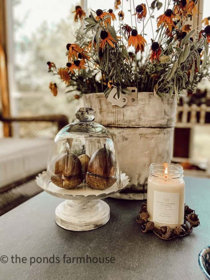 Glass dome with faux acorns.