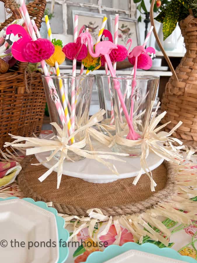 Hawaiian Party Ideas with raffia tied glassware and flamingos on straws.   