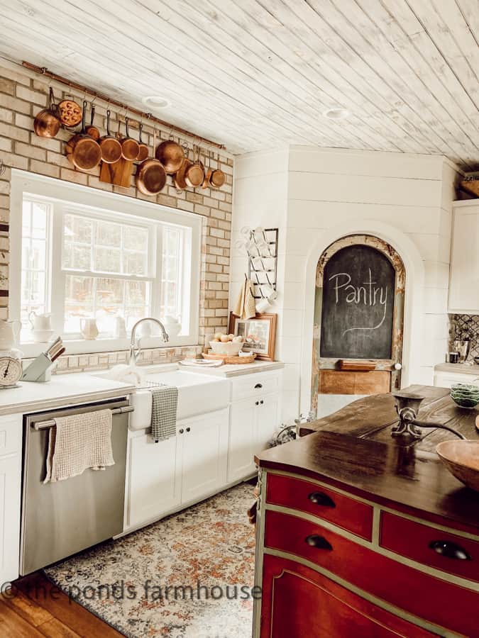 Farmhouse Kitchen Sink with concrete countertops and brick back splash  and DIY Pantry Door & Copper Pots