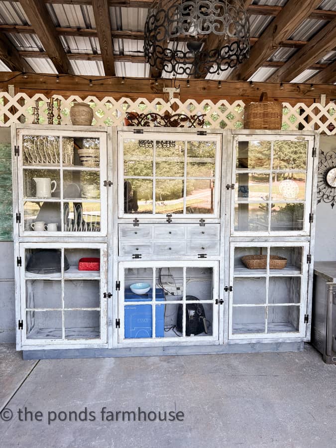 Rustic DIY outdoor kitchen cabinet with tv stand and faux front drawers.