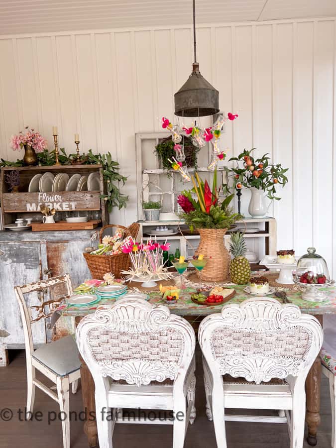 Hawaiian themed party set up on screened porch with festive table decorations.