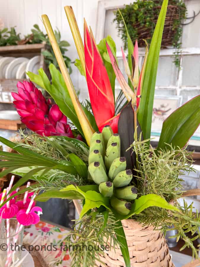 Tropical Centerpiece with mini bananas in a woven basket vase. 