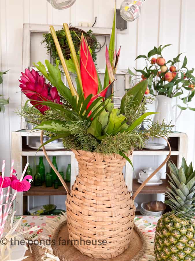 Tropical Centerpiece with mini bananas in a woven basket vase. Thrift store basket and fresh pineapple. 