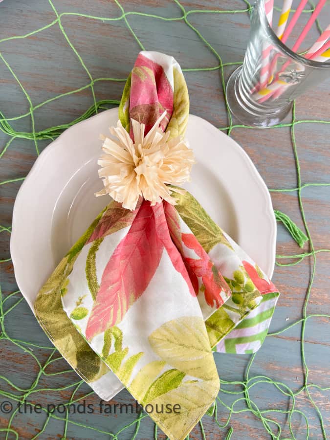 How To Make Tropical Napkin Rings Dupe for less than $5.00 with thrifted napkin rings and a recycled grass skirt. 