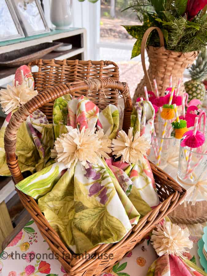 DIY Tropical Napkin Ring Dupe with straw pom poms and hawaiian print napkins.