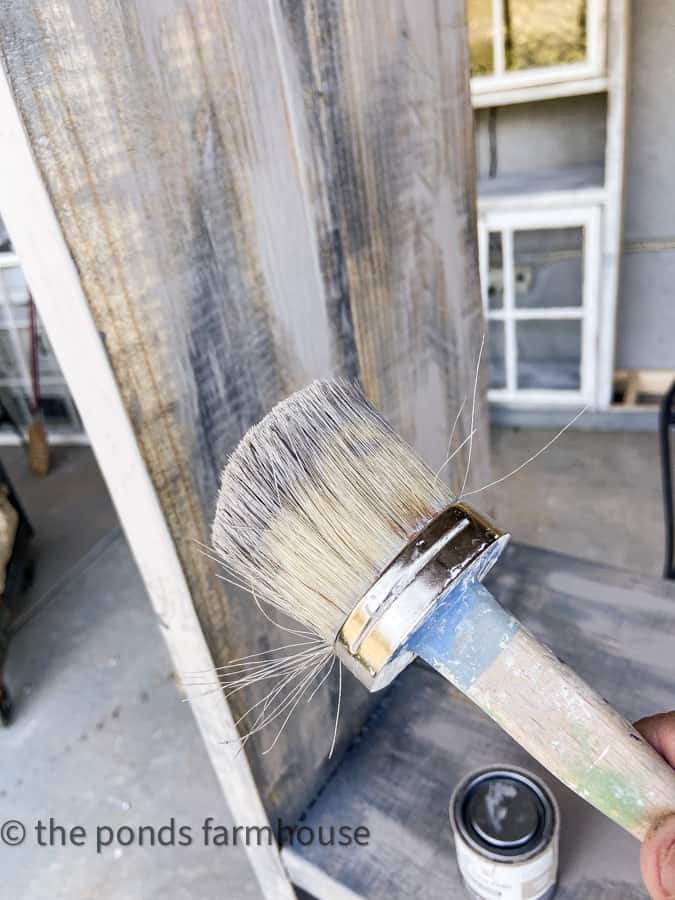 White paint being added to base paint to give barn wood effect to shabby chic cabinet.