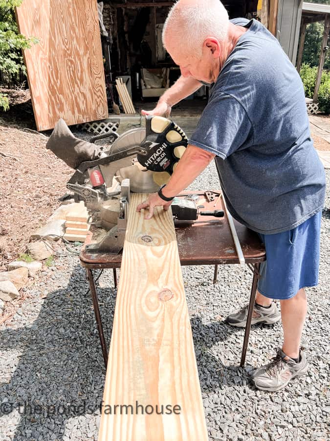 Sawing board to proper length for reclaimed window cabinet.