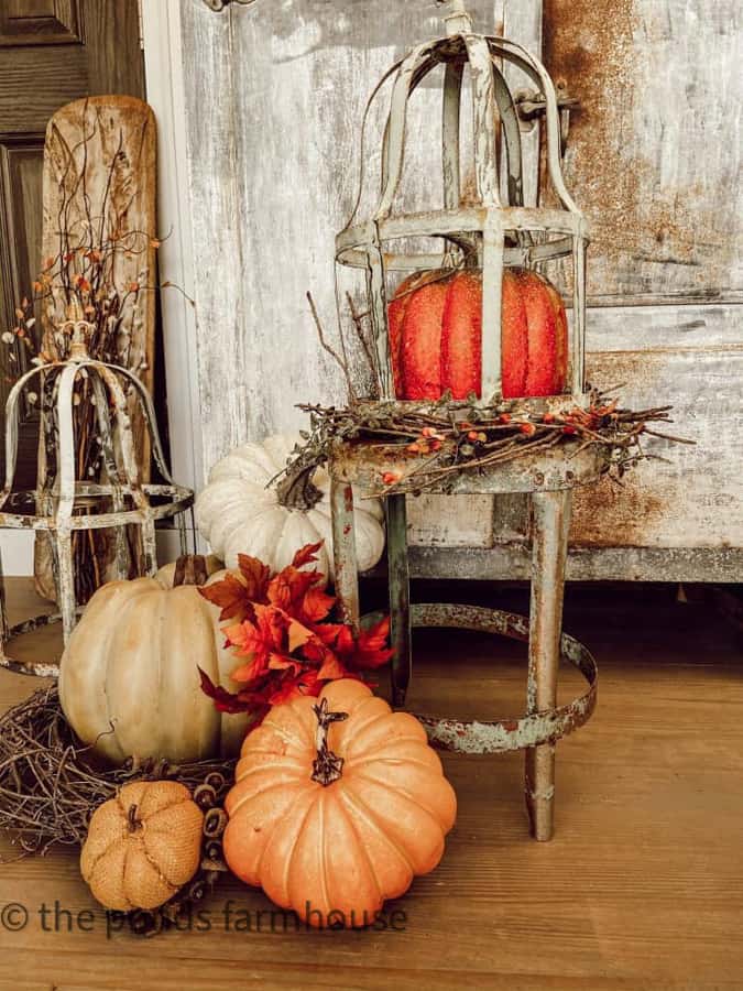 Wire dome with faux pumpkins.