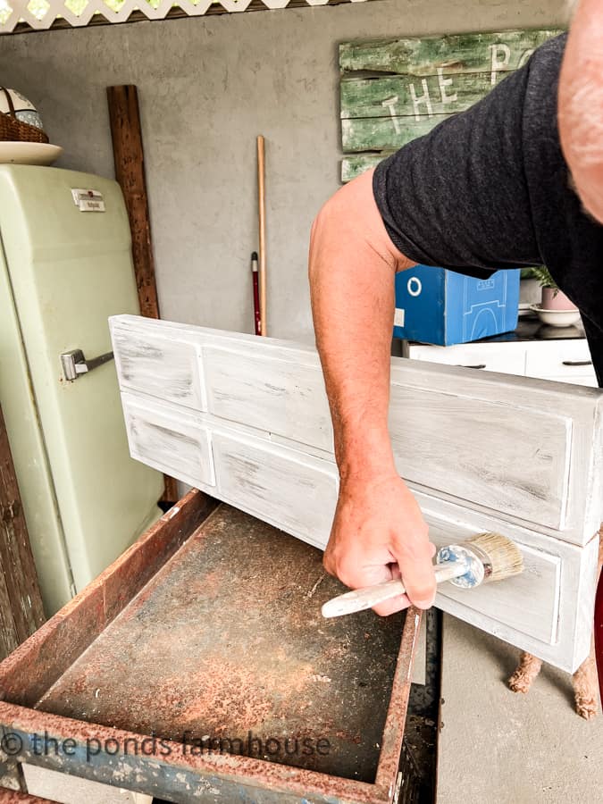 Faux door fronts being painted to look like old barn wood.