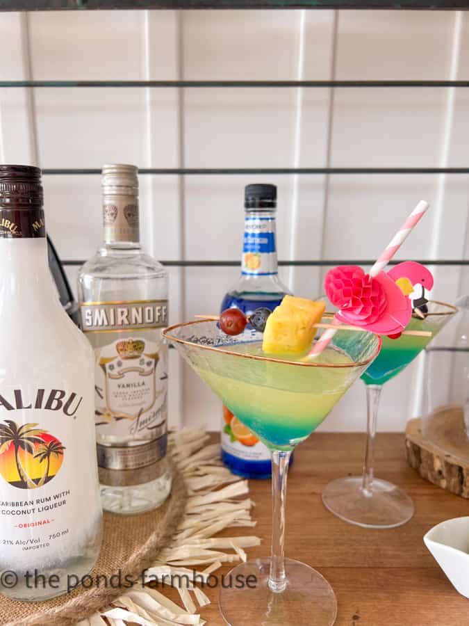 Pina Colada Martini with fresh fruit on a skewer and a pink flamingo straw.  