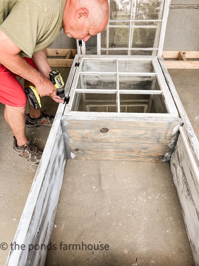 Attaching reclaimed windows to shabby chic cabinet.