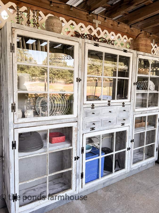Vintage Reclaimed window DIY outdoor kitchen cabinet. Vintage plates and cups and saucers & farmhouse style