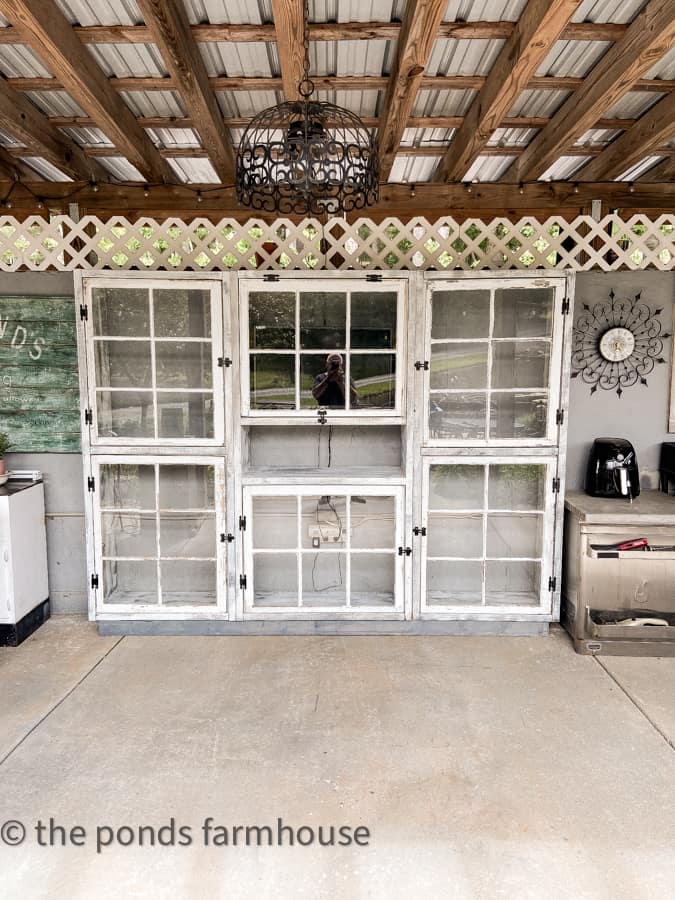 Reclaimed old windows from 1940's beach cottage upcycled into an outdoor kitchen cabinet.