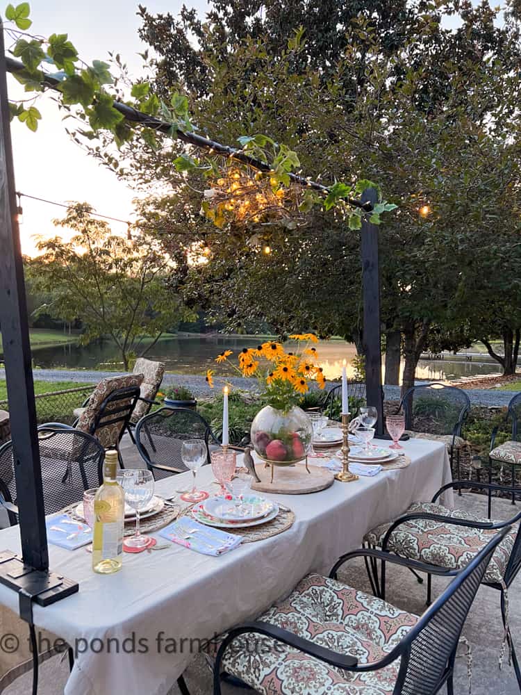 DIY Over the table stand with twinkle lights and deconstructed lamp shades with grapevine on summer tablescape