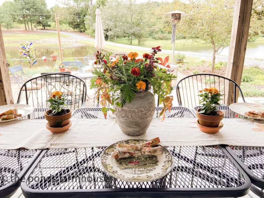 DIY Pottery Vase used for inexpensive fall flower arrangement on outdoor kitchen tablescape.  