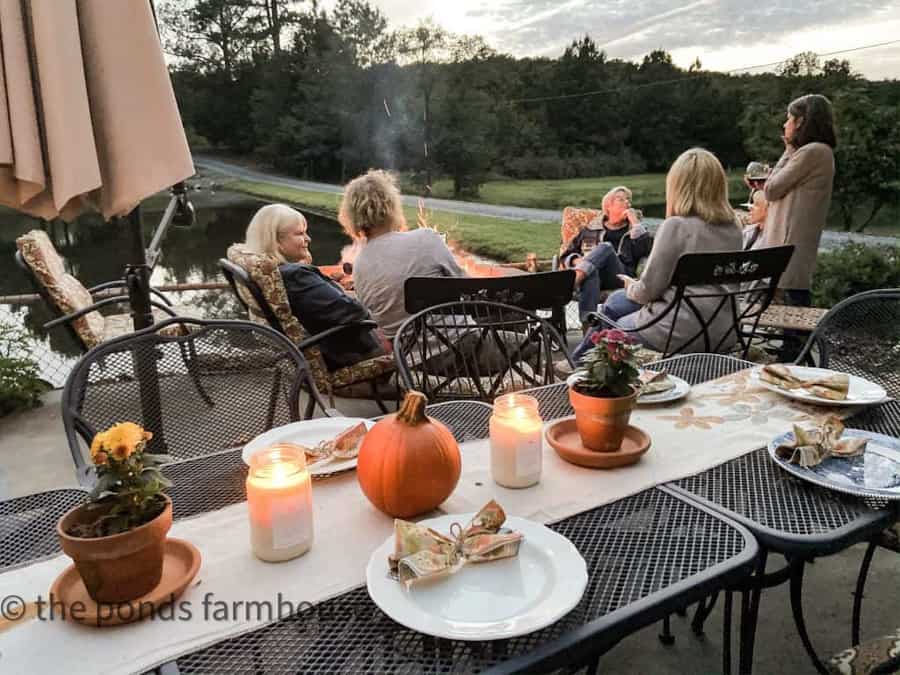 Friends gathered around the fire pit for outdoor entertaining ideas.