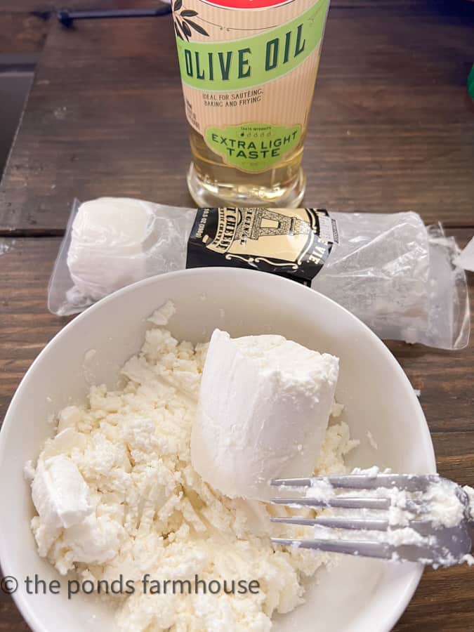 Add Olive oil to the goat cheese to  increase spreadability.  
