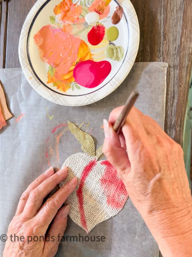 Paint the burlap coaster with craft paint to distinguish the design.