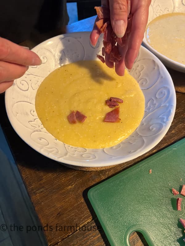 Add country ham to the top of the cheesy grits for a southern dinner.