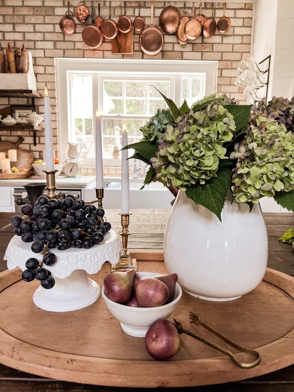 Kitchen Island Centerpiece with hydrangea and grapes with copper pots for Kitchen Fall Decor Ideas.