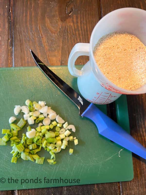 Chopped green onion and grits for southern shrimp and grits recipe.