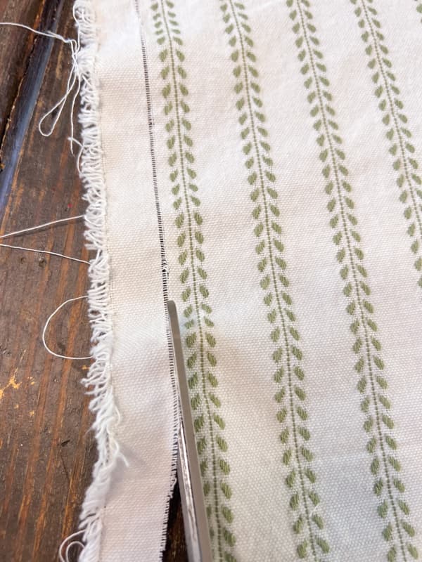 Cut along the pulled thread line for a straight on the grain line.