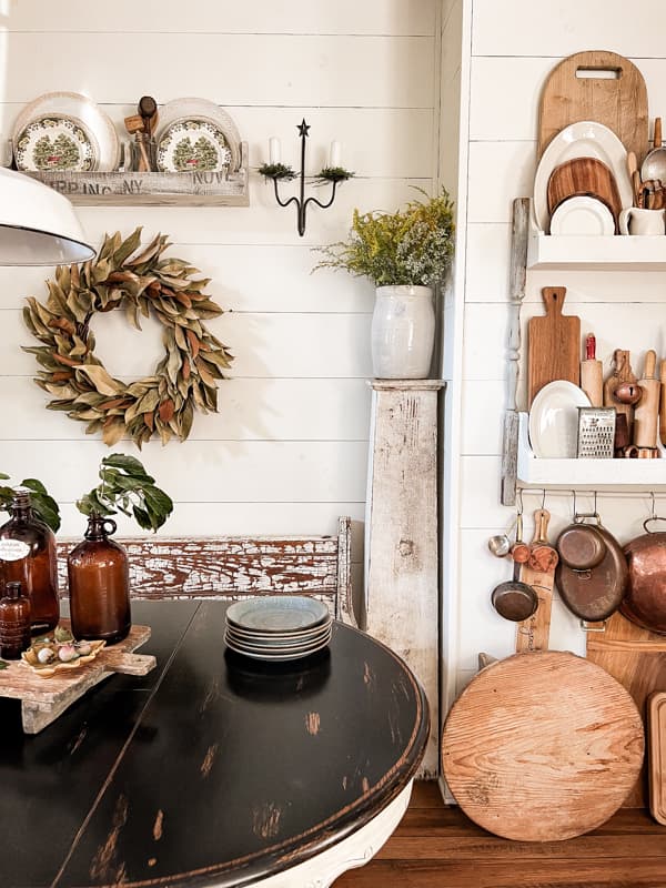 Autumn Decor included vintage fall dishes and DIY Wall Plate Rack with breadboards, copper and a magnolia wreath.