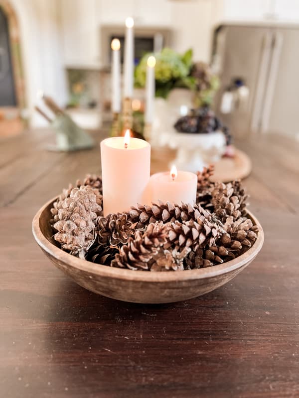 Foraged pinecones in wooden bowl with candles on the kitchen island for Cheap fall decor and Budget Kitchen Decorating Ideas