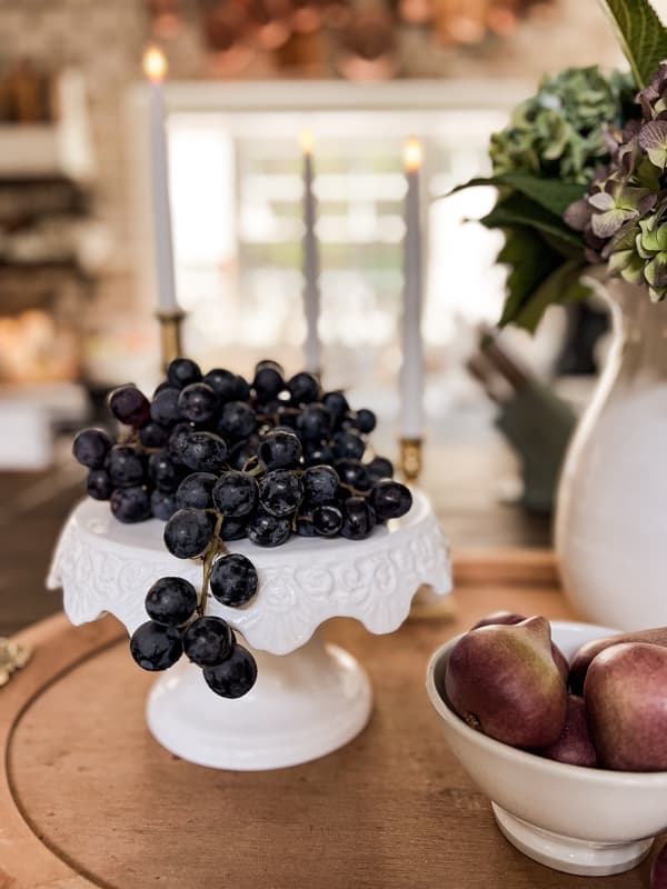 white cake stand with purple grapes for cheap fall decor ideas