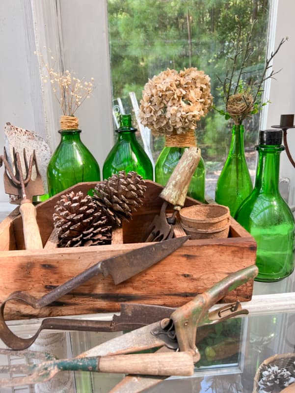 Old Bottles to decorate for fall - thrift store and junk pile finds with dried hydrangea and vintage tool box