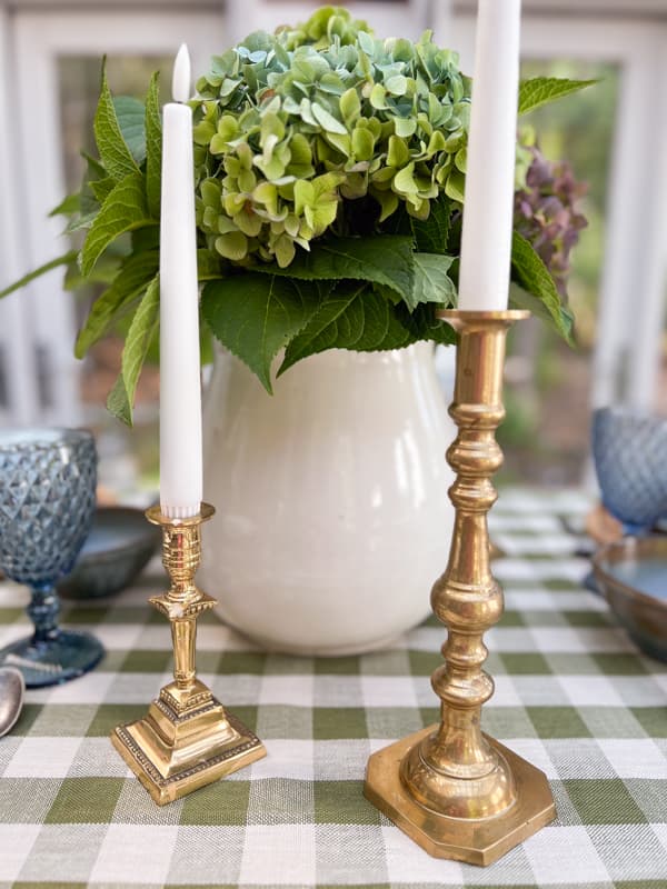brass candlestick and ironstone vessel with hydrangeas for potluck ideas cheap centerpiece