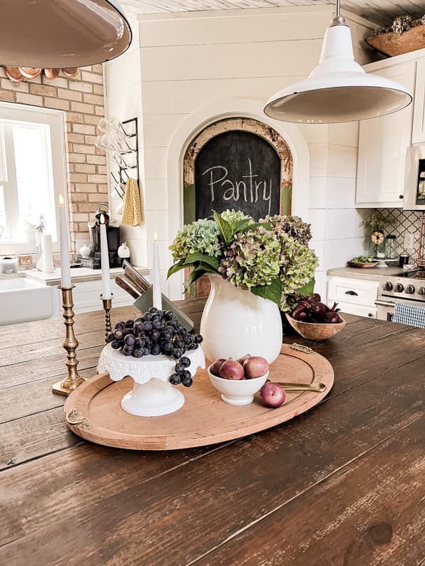 DIY Kitchen Island Centerpiece with fresh hydrangea blooms and grapes as centerpiece for cheap fall decor.