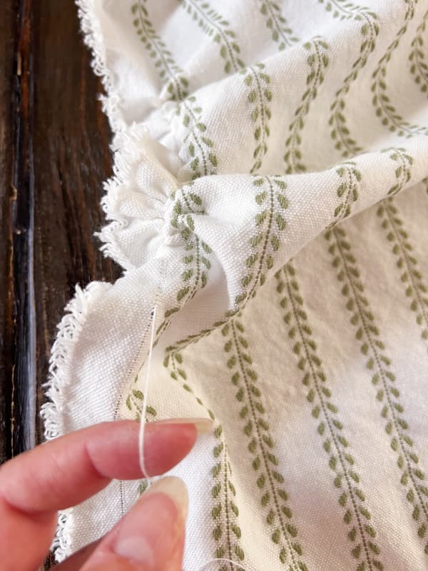 Pull thread to follow grain of fabric.