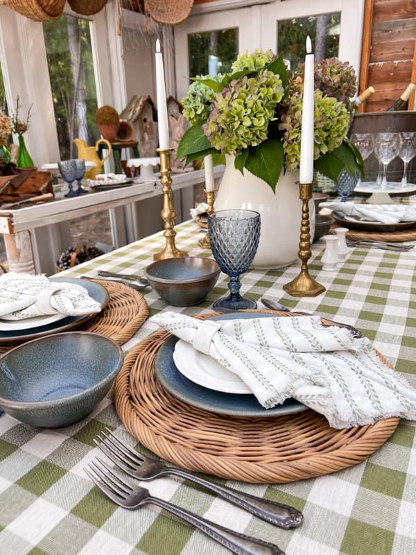 Southern Potluck Dinner Party table setting in the greenhouse for a farmhouse style tablescape. 