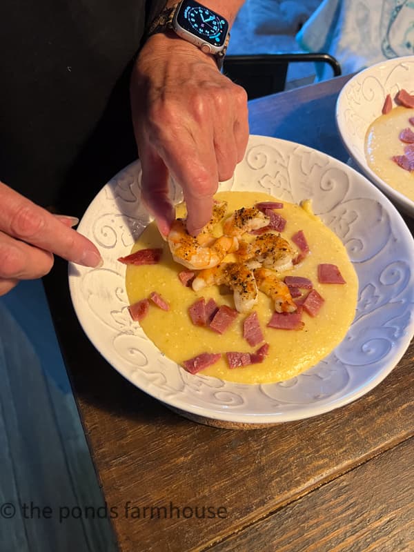 add grilled shrimp to the top of the cheesy grits and country ham.