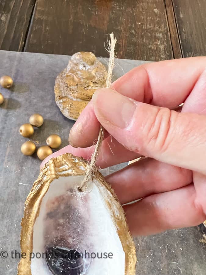Use jute string to tie shell onto the oyster shell garland
