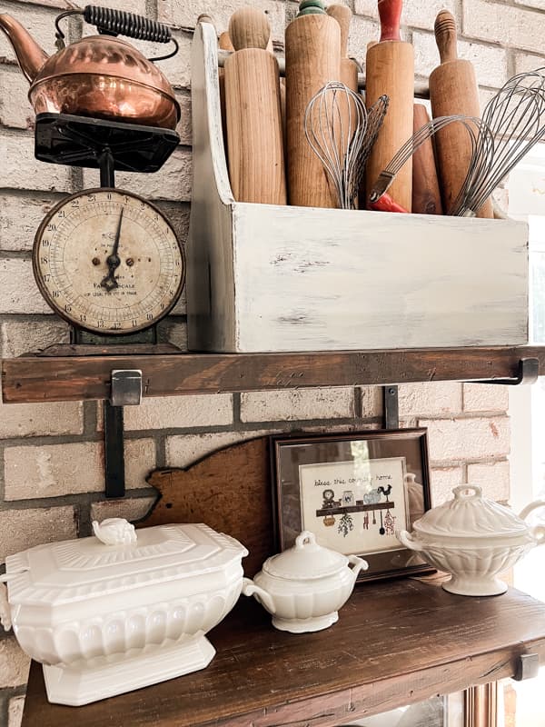 Decorate Open shelving with cottage core art and collections of ironstone for Budget Kitchen Decorating Ideas