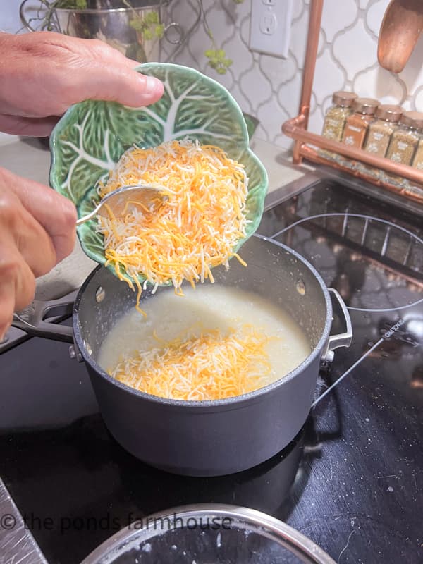 Add shredded cheese to the cooked grits.  