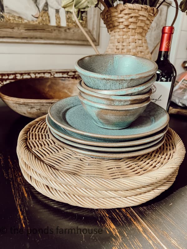 Rattan woven placemats with vintage pottery dishes.  