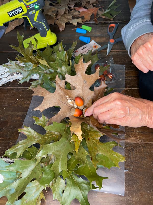 Add faux acorns to center of oak leaves for budget-friendly fall decorations