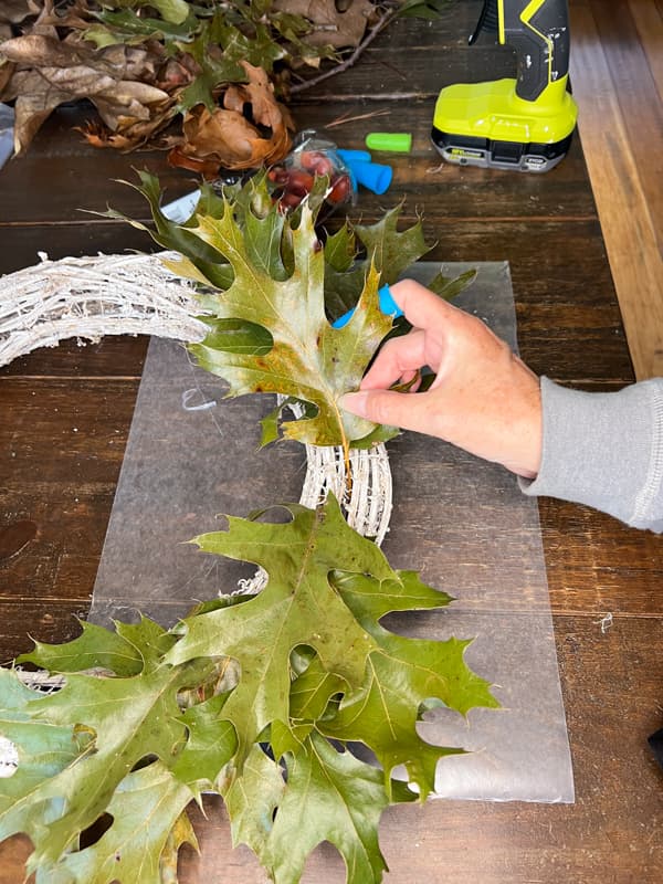 Add green leaves to make a wreath for fall with foraged materials for budget-minded fall decorating.