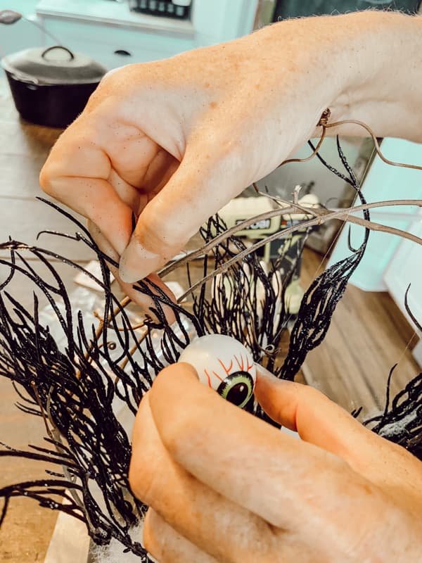 Add eyeballs with hot glue to make a DIY Halloween Centerpiece with Dollar Tree DIY Centerpiece Decor.