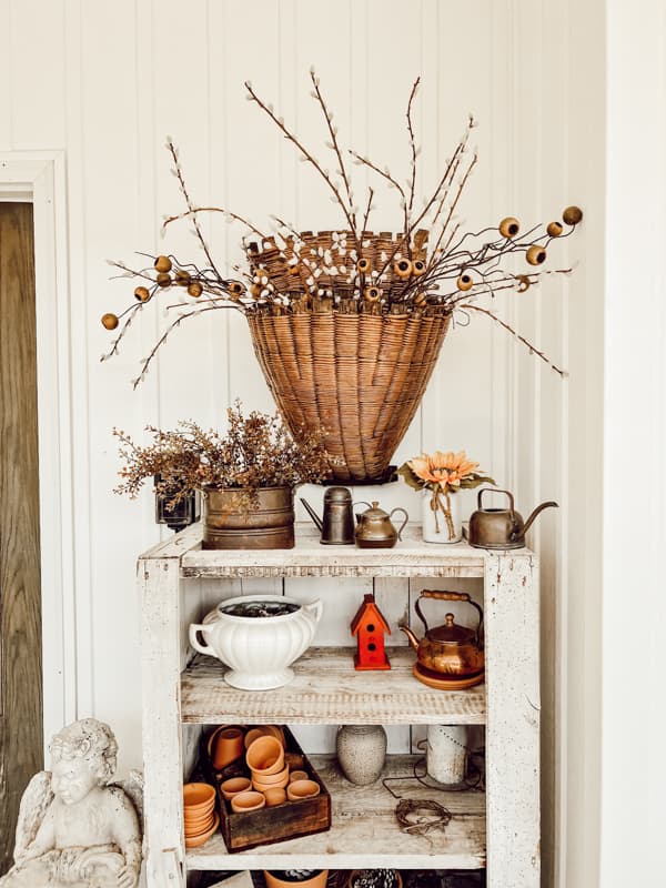 Vintage hutch with vintage cooper, clay planters.