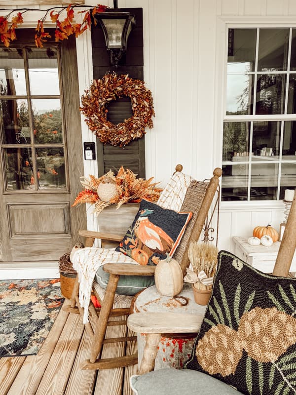 Hand-hooked pillows on rocking chairs for fall decorating