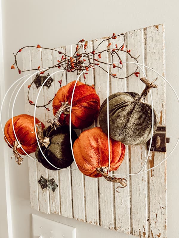 DIY crafted Pumpkin wreath form with velvet pumpkins for country rustic Fall Decorating.